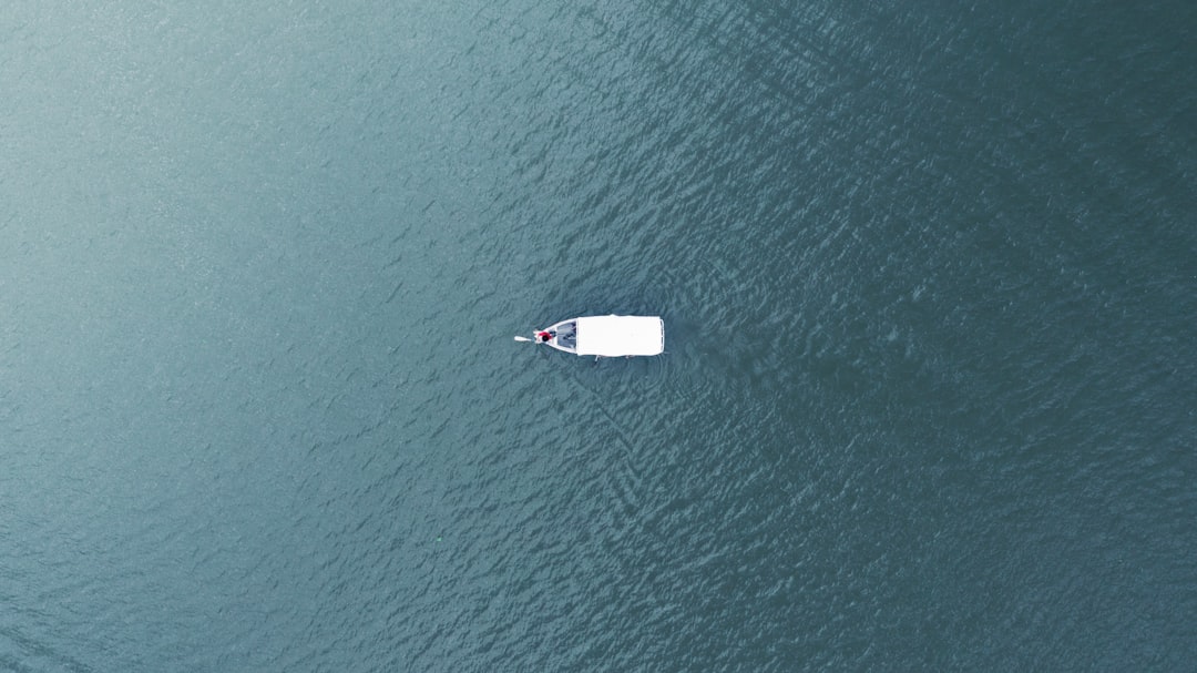 a small boat floating on top of a large body of water