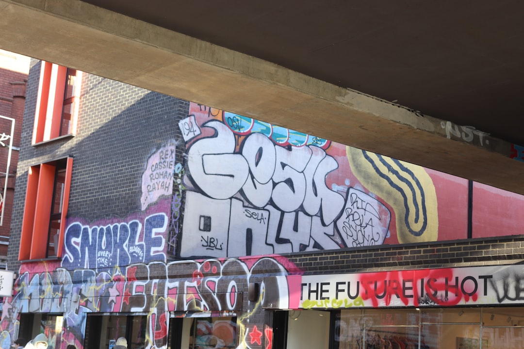 Graffiti art covers a brick building wall.