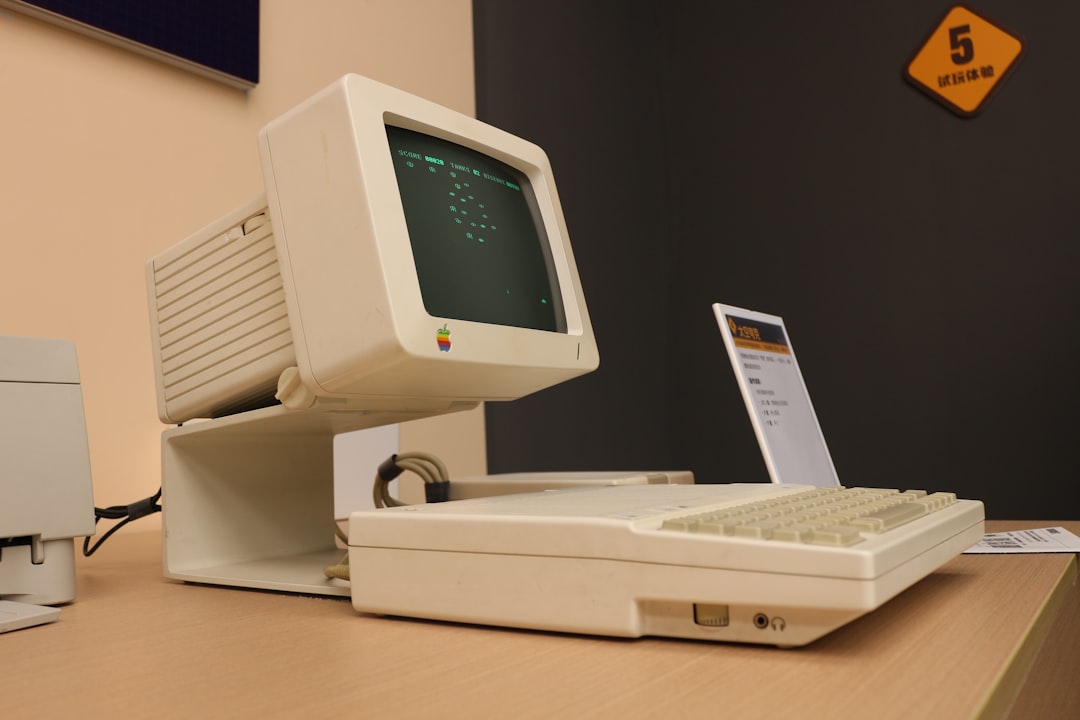 A computer sitting on top of a wooden desk